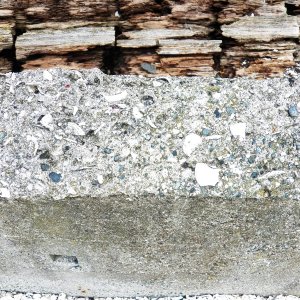 There were a few concrete footings made from "gravel" from the beach.  You can see that it's 20% shell.