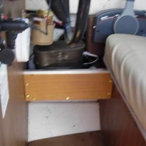 Shelf next to helm. Storage for binoculars, spot light, and loud hailer.