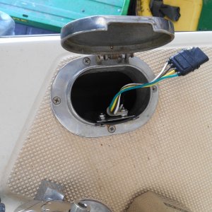 There seems to be some interest in the remote switch so...  First I sealed the old hause hole slot.  I used trailer wiring and connectors, female here to contactor.  The switch simply parallels the panel switch; middle-common to fused +12volts, up to up, down to down on the contactor.