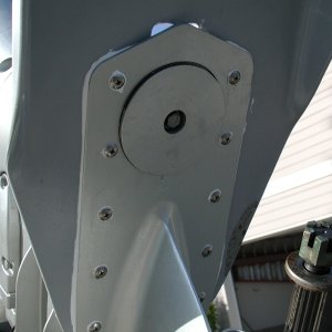 Starting the water pump impeller project entails dropping the lower case. The hidden bolt is under this cover. In a single engine application, there may be a trim tab here.