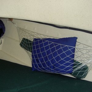 Gear storage hammocks in v-berth.  Oak bases with hooks are epoxied to the side of the  hull.  Very handy and they don't intrude very much into the berth.