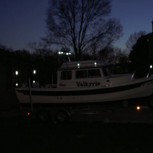Reflective tape (ACR) added to make vessel more visible when anchored at night or when in distress.  A package of 12 sheets ($25 at West Marine) will do the whole boat.  Tape was added to bimini frame, radar arch, cabintop handrail supports and bow pulpit.  Highly effective at night, but not noticeable during the day.