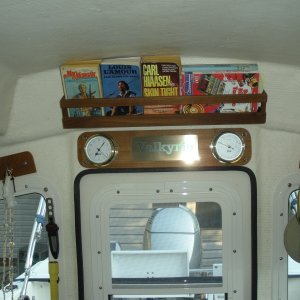 Teak book rack over the door, making use of the high-top's extra space.