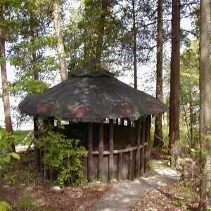 He built this gazzabo with a "flower" looking shingled roof.  He built the gazzabo so his wife would come and read while he worked on the cottage.