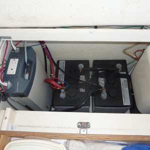 Two 6 volt sealed batteries and a 3000 watt inverter under the dinette seat.  Will power the microwave, coffee pot and electric skillet. Recharges batteries when running the generator or with shore power.