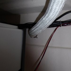 Media 'Shadows create an optical illusion, the wiring and cables are actually separated from the exhaust by a good 4 inches.  The exhaust port also has a guard tacked to the top of it so really it's impossible for the wires to come into contact even if somehow they fell or sagged.' in album 'After working on the Wallas installation for 4 hours on the workstand, I decided to launch and finish the project on the water in Anacortes. Who's that in the background?'