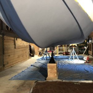 Once exterior repairs to the hull were made, three layers of Pettit epoxy primer were applied as a barrier coat. What appears to be dark blue paint in this photo is the same gray primer, just in shadow.