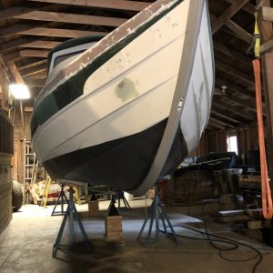 Media 'Two layers of Pettit Vivid bottom paint were applied over the primer coats. The original brass keel guard was removed, the screw holes were drilled out and filled with thickened epoxy, then the keel guard was re-installed. The newly applied bottom paint was sanded away where a new 8' KeelGuard would go, and it was installed over the original keel guard.' in album 'Hull repair'