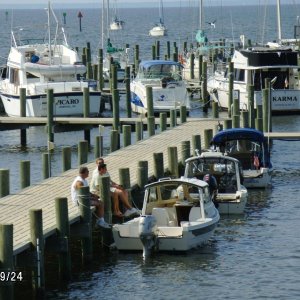 Larry, Bill & Tivo sitting on dock trading boat stories..Whittaker's Pointe Marina