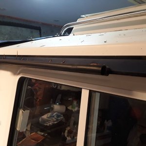 Media 'Widow "gutter" made from press-on gasket material used for sealing hatches.  It is available in 180 and 90 degree (this is 90 degree used to form a gutter to keep rain from dripping in the captain's window.  I used the 180 degree for "head protection" above the cabin entrance.' in album 'My windows didn't open enough to comfortably hang my elbow out while at the helm.'