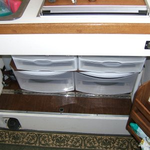 Media 'storage for pots and pans below hinged swing up door - pull out plastic drawers for plates, etc.' in album 'custom drawer and separated storage below front seat'