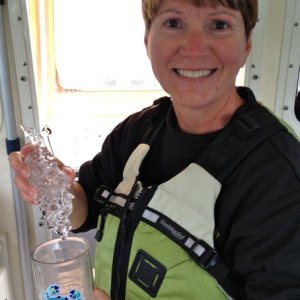 Mary about to cool her drink with a "bergie bit".