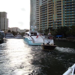 Aft view of Retro boat under tow through river. Big boats frequently use tugs for liability reasons.