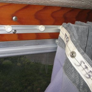 Sliding curtains, detail of track, plastic cars, and fabric tape with snaps,(all made by Recmar) sewed to curtain material.