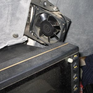 This fan is made from a 12 volt computer fan.  The brackets are from a transom mount transducer. The fan can be rotated to blow on the drivers window, center window or both.