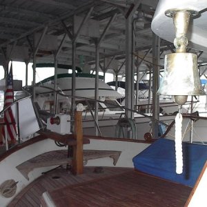 Foredeck with anchor windless, lots of teak, and fog bell.