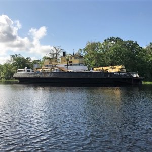 Noble Phoenix in Murphys Creek. Notice the AirStream trailer and two city buses on it\'s decks.