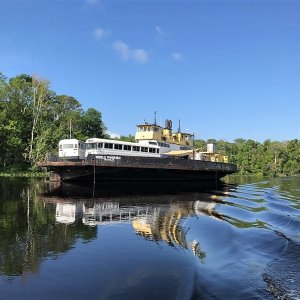 Noble Phoenix in Murphys Creek. Notice the AirStream trailer and two city buses on it\'s decks.