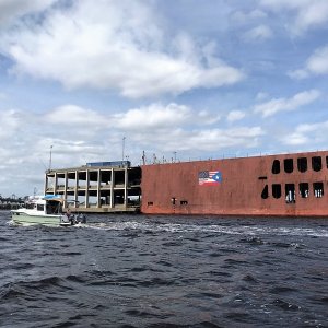 This cargo ship was being loaded with semi trailers.