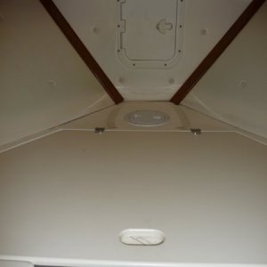Media '1st - a large forward "V" shaped storage locker. 
2nd - 6" round access hatch to the inside of the stem and under the anchor locker. This hatch gives clear access down under the "V" storage locker and under the cabin sole to the cabin 6" access access hatch at the inside of the door bulkhead.
3rd - Rectangular Hatch cover opens to the anchor locker.' in album 'Cutty, Forward to Port.
Wooden boat paddle held up under port forward deck.
Access hatch to storage locker.'