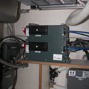 These are the electric/hydraulic controllers for the Teleflex/Morse fore and aft control stations. They cover the "Y" valve for the head tank macerator discharge. The Wallas stove can be seen at top.