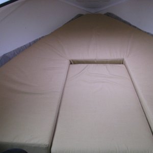 Media '06 Berth Cushion in place.  Please note we cut the HyperVent 6 inches in circumferance larger than the Berth cushion to allow the Hypervent to extend up the sides.  IMPORTANT UPDATE JULY 2012.  We had to cut the excess hypervent material to just fit the berth cushion's dimensions after several restless nights sleeping.  We found that the original configuration caused the berth cushion to curl up slightly along the sides, forcing us to sleep in the middle.  The manufacturer's instructions were right!  We now sleep soundly, with no condensation underneath the cushion.' in album '00 Hypervent cross section and flap'