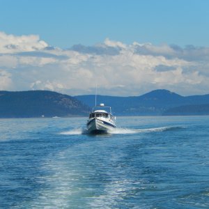 Robbie's Refuge crossing Rosario Strait 
in See-Saw's wake, 
going to Friday Harbor for the gathering