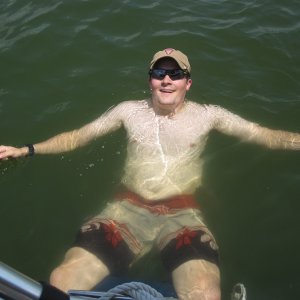 Son-in-law J enjoying very warm water in PK while sitting on a fender.
