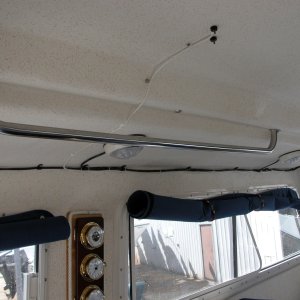 Media '(Sea Angel) Port Side Grab Rail with factory window covers rolled up and held with small bungie cords.
Note WX Station between port windows and variable speed fan above Mate's seat.' in album 'Toys are all in: Raymarine 4KW radar w/ C80 display, Garmin 2006C w/fish finder , ST6001 Autopilot, NAVMAN 3100 Fuel Flow management system, ICOM M502 VHF and Standard Signaler/Hailer. Love those toys; especially the radar chart overlay & fuel management system.'