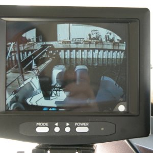 View at dock after landing. This first landing was very smooth, all helped with improved line of sight. Yes, that is my hand reflection on the monitor as I took the pix. The curve at the top of the pix is the underside of the camper back top.
A replacement LCD Monitor has since been moved to above the starboard winshield after the original succumbed to spray thru the center window.