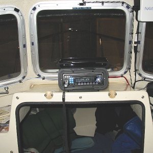 Enclosure velcroed to acrylic base. $7.00 wire Antenna(SeaWorthy Sea-Ant) bundled with speaker wires to port. Stereo is full-featured but cheap($79.88). Plays MP3s, has USB port,SD media slot, accepts I-Pod, and sports 45watts/channel