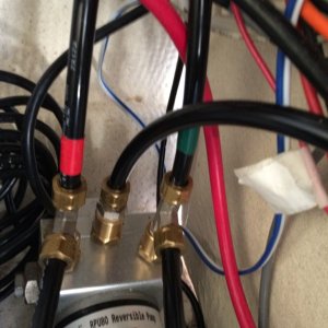 12V DC motor, controlled by autopilot computer, drives hydraulic piston mounted on Nisson.  Two lower hoses go to helm pump for manual control of Nisson.