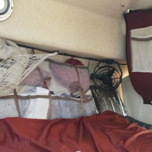 vberth with hammock over clothes organizers over reflective window panels