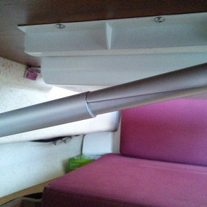 The upper side of this bracket pops up and this allows the table to fold down against the hull.  The bracket holds tight is all conditions we have encountered despite the flimsy appearance.