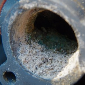 Media 'I started cleaning up the thermostat seat area by just scraping, but I could see that it would not result in a smooth seat.' in album 'The thermostat and the cover had some build up.  Good thing I was careful removing the gasket, as the new thermostat did not come with a new gasket.'