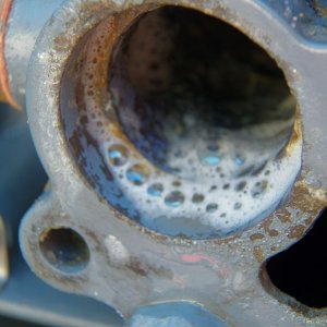 Media 'I switched to industrial vinegar (10%) and later to muriatic acid.  That cleaned things up in a hurry.  I actually soaked the old thermostat clean and kept it for a backup.  A car thermostat, which doesn't get any build up, is good for decades.  Why not an outboard thermostat with the build up dissolved periodically?' in album 'The thermostat and the cover had some build up.  Good thing I was careful removing the gasket, as the new thermostat did not come with a new gasket.'