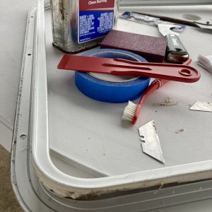 Media 'While the balsa was airing out and I waited for an order of epoxy I set to clean all the caulk residue from the hatch frame .' in album 'The main hatch has has been leaking for a while but I wanted to get off the great lakes before taking it apart (I made a quick and dirty rain cover that attached into the four existing snaps for the sun shade)'
