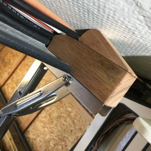 Fitting the hinges for the table. The wires that run athawartships between house and engine batteries fit nicely on top of the hinge supports.