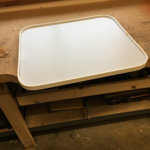 With a heat gun, I bent a piece of flexible molding around the table for the rocking lip. Used a nail gun to hold it in place. Then putty for the nail holes.