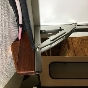 Underneath view. The hinges are screwed to the wood supports with three screws, two through the fiberglass crossmember.
