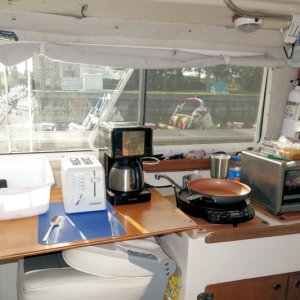 Media 'Galley extension over helm seat with 110AC outlet freed up after removing water heater and getting more storage cabinet space' in album 'berth with topper from amazon.com.  Marinebeam 18-LED lights.  Cabin 9 white, 3 red LED provide what E calls "that New Amsterdam Bordello effect" for when you want that.'