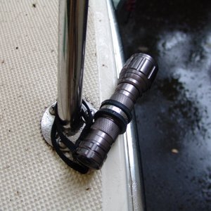 A 1" rubber covered stainless clamp from West Marine holds them in place using an existing bolt. The supplied lanyard hangs on as well in case something breaks.