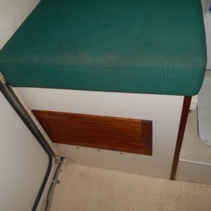 Teak louvers match those ventilating the fridge.
