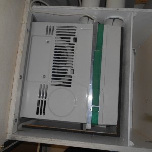 Media 'The unit is retracted when not in use.  In the Fall, it's easily lifted out and stored in the garage, leaving this space for storage.' in album 'It was either add air conditioning or not sleep on the boat all summer.  Here the unit is stored when not in use.'