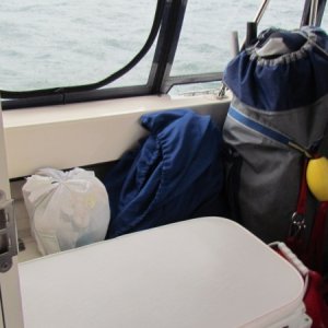 cruising cockpit complete with dink and motor (behind the towel) trash to go ashore,laundry bag