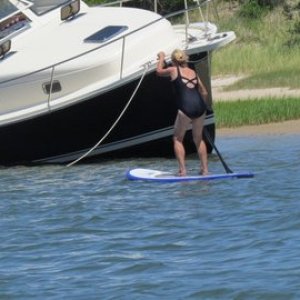 this boat moved into shallow water and let the tide go out so he could clean the  bottom,just getting ready to refloat here on the incoming tide. My wife paddling by on her first paddle board excursion