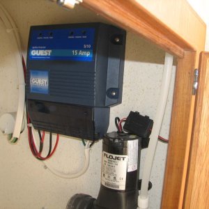 Charger on stern wall in galley cabinet