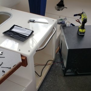 Removed frig to install kneeling grab-bar and eye bolts for cargo straps.