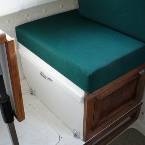 Media 'Most of the seat was recycled from the original seat box. Front, side and bottom panels were added along with the floor/deck. All painted to match.' in album 'Sliding seat in new position. 

A lumbar pillow is nice to use here. We often sit on a PFD cushion for a better look-out/view. Not pictured here, I added a snap under the table and a small strap snaps into it and then snaps onto the existing cushion snap. This hold the back-rest cushion in place.'