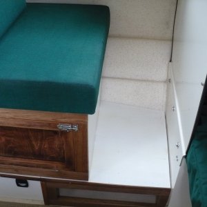 Media 'Open storage under foot. I used porch paint and a clear coat on the raised floor decking. It's held up good after 2 seasons.' in album 'Sliding seat in new position. 

A lumbar pillow is nice to use here. We often sit on a PFD cushion for a better look-out/view. Not pictured here, I added a snap under the table and a small strap snaps into it and then snaps onto the existing cushion snap. This hold the back-rest cushion in place.'